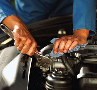 Hands of mechanic fixing enginejpg